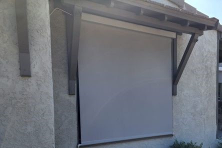 Exterior view of the motorized roller shades fully lowered, providing shade and privacy for the South Pasadena residence